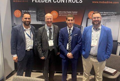 Four visitors and team members at the MOBADRIVE booth at Automate 2026 in Chicago.